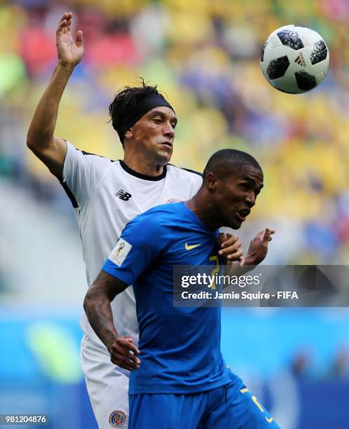Christian Bolanos of Costa Rica wins a header over Douglas Costa of Brazil during the 2018 FIFA World Cup Russia group E match between Brazil and...