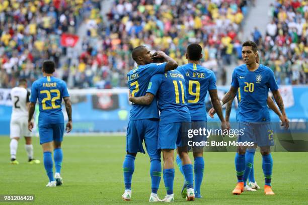 Philippe Coutinho of Brazil celebrates with teammate Douglas Costa after scoring his team's first goal during the 2018 FIFA World Cup Russia group E...