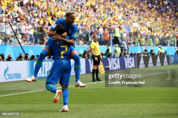 Neymar Jr of Brazil celebrates with teammate Douglas Costa after scoring his team's second goal during the 2018 FIFA World Cup Russia group E match...