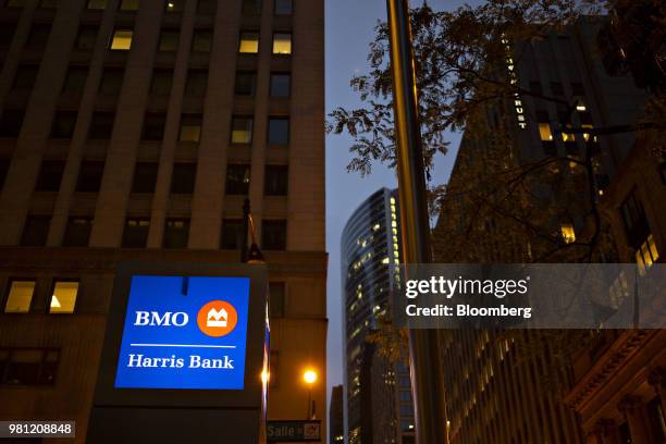 Signage is displayed outside the BMO Harris Bank NA headquarters building at night in Chicago, Illinois, U.S., on Monday, June 11, 2018. Bank of...