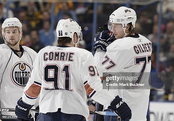 Tom Gilbert of the Edmonton Oilers talks with teammate Mike Comrie during a game against the St. Louis Blues on March 28, 2010 at Scottrade Center in...
