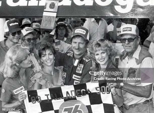 Dale Earnhardt celebrates in Victory Lane with wife Teresa, car owner, Bud Moore and the Winston Cup girls. Earnhardt would take home $46,950 for the...