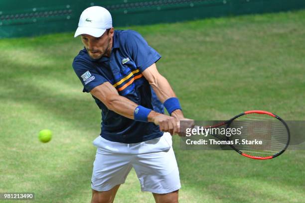 Roberto Bautista Agut of Spain plays a backhand in his match against Karen Khachanov of Russia during day five of the Gerry Weber Open at Gerry Weber...