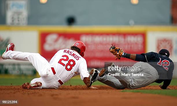 Second baseman Alexi Casilla of the Minnesota Twins catches Colby Rasmus of the St. Louis Cardinals stealing at Roger Dean Stadium on March 29, 2010...