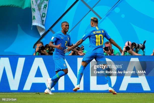 Neymar of Brazil celebrates scoring a goal with Douglas Costa to make it 2-0 during the 2018 FIFA World Cup Russia group E match between Brazil and...