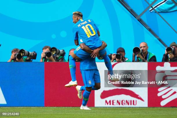 Neymar of Brazil celebrates scoring a goal with Douglas Costa to make it 2-0 during the 2018 FIFA World Cup Russia group E match between Brazil and...