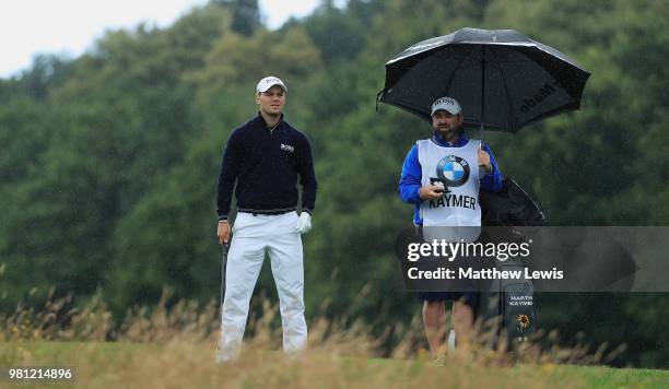 Martin Kaymer of Germnay looks on with his caddie Craig Connelly during day two of the BMW International Open at Golf Club Gut Larchenhof on June 22,...