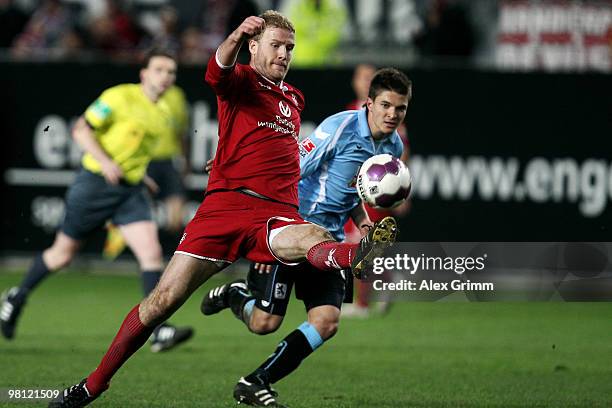 Adam Nemec of Kaiserslautern is challenged by Aleksandar Ignjovski of Muenchen during the Second Bundesliga match between 1. FC Kaiserslautern and...