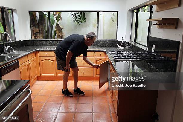 David Sandlin checks out the kitchen in a short sale home on March 29, 2010 in Miami, Florida. On April 5, 2010 lenders and mortgage investors will...