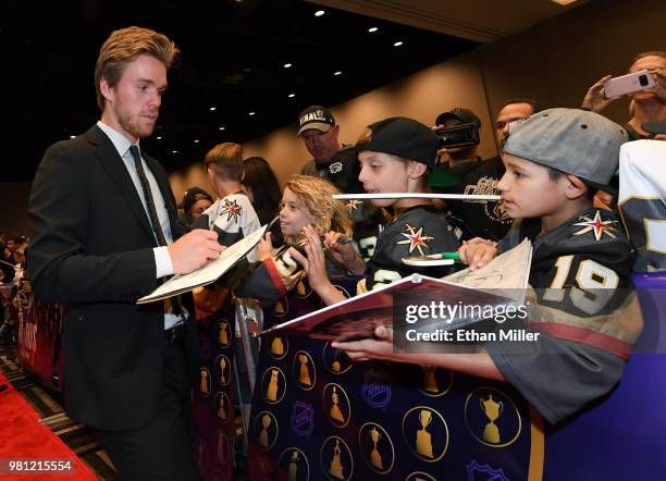 Connor McDavid of the Edmonton Oilers signs autographs for fans as he arrives at the 2018 NHL Awards presented by Hulu at the Hard Rock Hotel &...