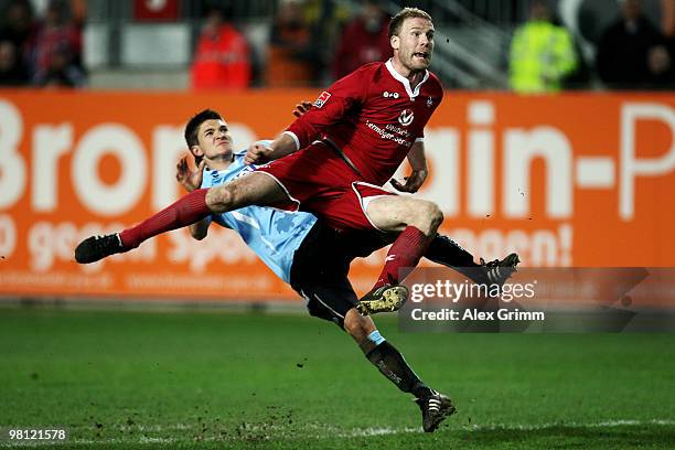 Adam Nemec of Kaiserslautern is challenged by Aleksandar Ignjovski of Muenchen during the Second Bundesliga match between 1. FC Kaiserslautern and...