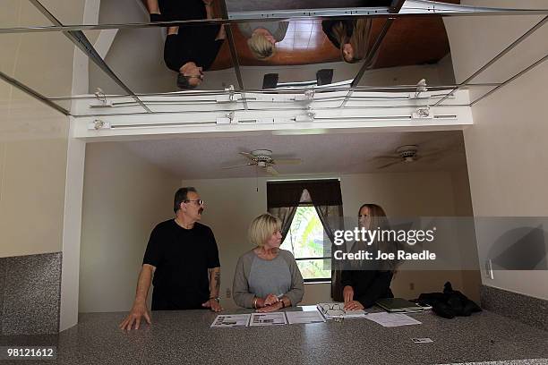 Real estate agent Shellie Young from Home and Business Realty, Inc. Shows a short sale home to Myra Sandlin and David Sandlin on March 29, 2010 in...