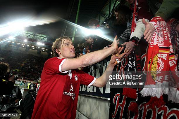 Martin Amedick of Kaiserslautern celebrates with supporters after the Second Bundesliga match between 1. FC Kaiserslautern and 1860 Muenchen at the...