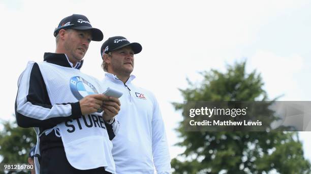 Henric Sturehed of Sweden looks on with his caddie during day two of the BMW International Open at Golf Club Gut Larchenhof on June 22, 2018 in...