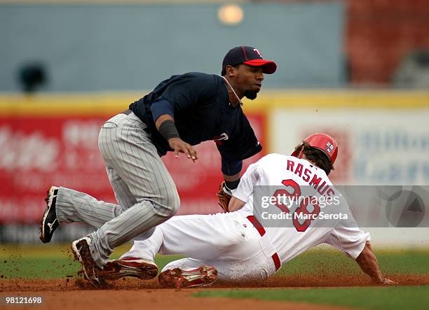 Second baseman Alexi Casilla of the Minnesota Twins catches Colby Rasmus of the St. Louis Cardinals stealing at Roger Dean Stadium on March 29, 2010...