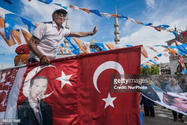 Man holds a flag with the image of Recep Tayyip Erdogan, candidate of the Justice and Development Party for presidential elections, during a...
