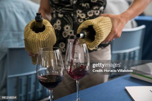 Red wine being served during "Taste The Difference" session presenting the same wine, bottled on the same day, under the same conditions, but sealed...