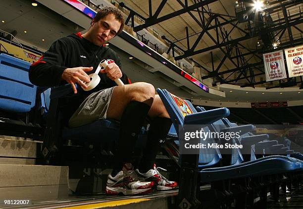 Goaltender Yann Danis of the New Jersey Devils tapes his stick in the stands before the game against the New York Islanders on March 13, 2010 at...