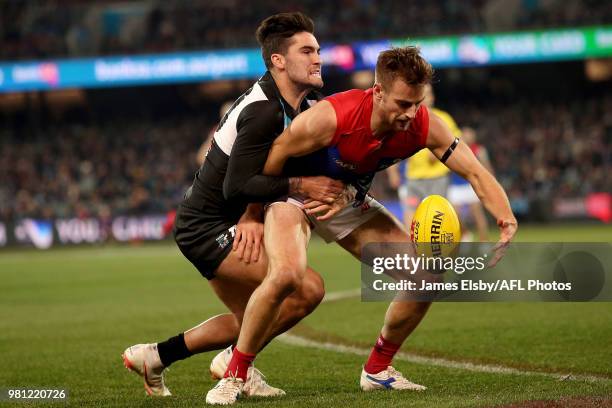 Chad Wingard of the Power tackles Dom Tyson of the Demons during the 2018 AFL round 14 match between the Port Adelaide Power and the Melbourne Demons...