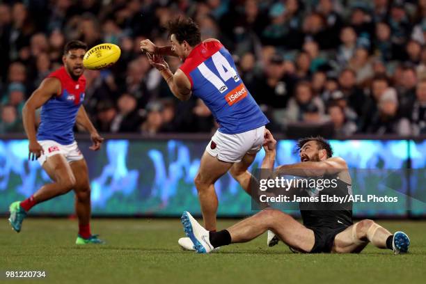 Charlie Dixon of the Power tackles Michael Hibberd of the Demons during the 2018 AFL round 14 match between the Port Adelaide Power and the Melbourne...