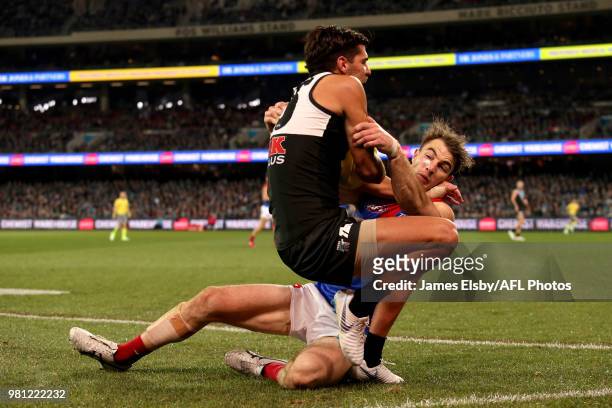 Riley Bonner of the Power is tackled by Tim Smith of the Demons during the 2018 AFL round 14 match between the Port Adelaide Power and the Melbourne...