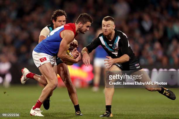 Joel Smith of the Demons is tackled by Robbie Gray of the Power during the 2018 AFL round 14 match between the Port Adelaide Power and the Melbourne...