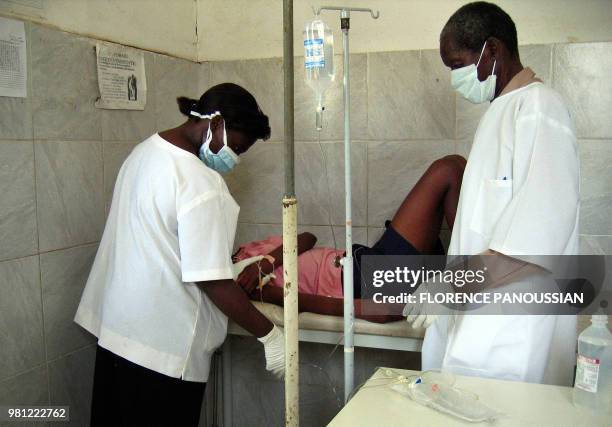 Angolan health workers treat, 05 April 2005, a 22-year-old woman, a new suspected case of the Marburg haemorrhagic fever in a clinic in Cacuaco...