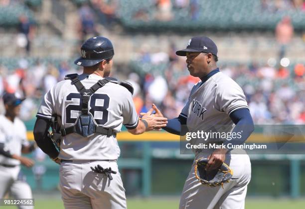 Austin Romine and Aroldis Chapman of the New York Yankees shake hands after the victory in game one of a double header against the Detroit Tigers at...