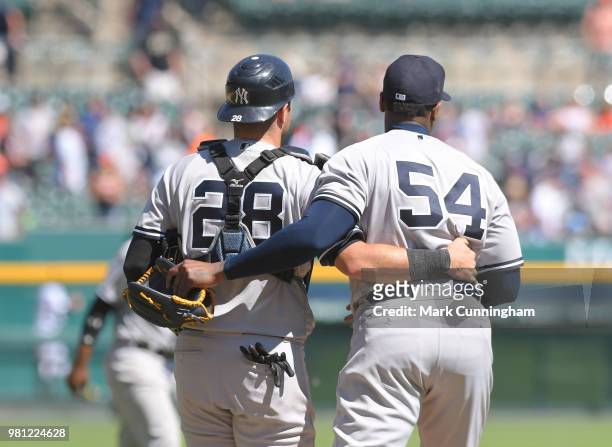Austin Romine and Aroldis Chapman of the New York Yankees hug after the victory in game one of a double header against the Detroit Tigers at Comerica...