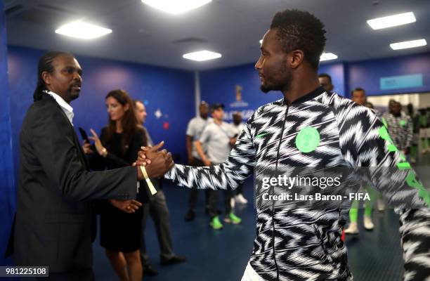 Former player of Nigeria Nwanko Kanu shakes hands with John Obi Mikel of Nigeria prior to the 2018 FIFA World Cup Russia group D match between...