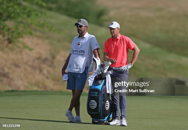 Jordan Spieth talks with his caddie, Michael Greller, on the 13th hole during the second round of the Travelers Championship at TPC River Highlands...