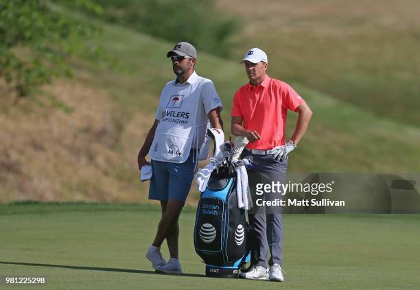Jordan Spieth talks with his caddie, Michael Greller, on the 13th hole during the second round of the Travelers Championship at TPC River Highlands...