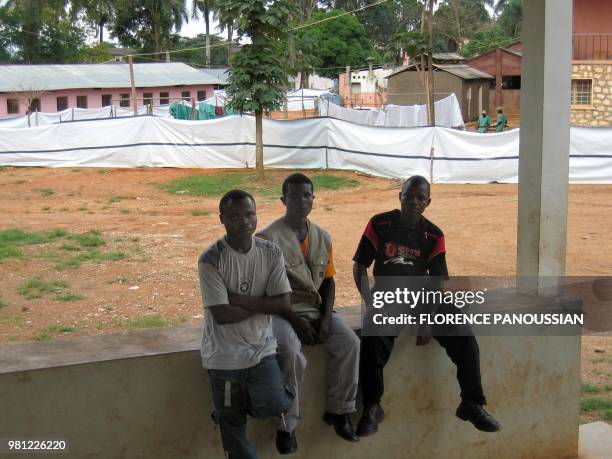 Local peole wait to visit a friend or relative under surveillance in the isolated area of Uige hospital after an outbreak of the deadly Marburg...