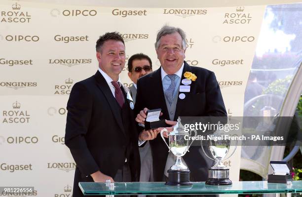Trainer Sir Michael Stoute is presented with his trophy by Michael Owen after winning the Commonwealth Cup with Eqtidaar during day four of Royal...