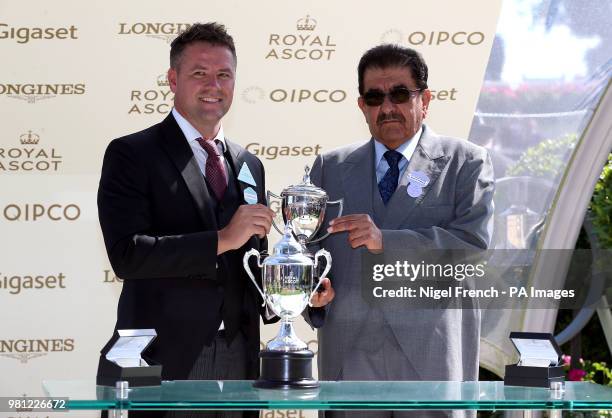 Owner Hamdan Al Maktoum is presented with his trophy by Michael Owen after winning the Commonwealth Cup with Eqtidaar during day four of Royal Ascot...