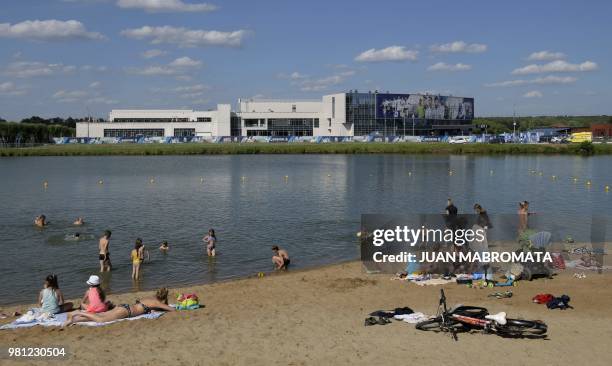 People enjoy the sun taking bath at the Belskoe lake in front of Argentina's base camp in Bronnitsy, near Moscow, on June 22, 2018. Argentina trains...