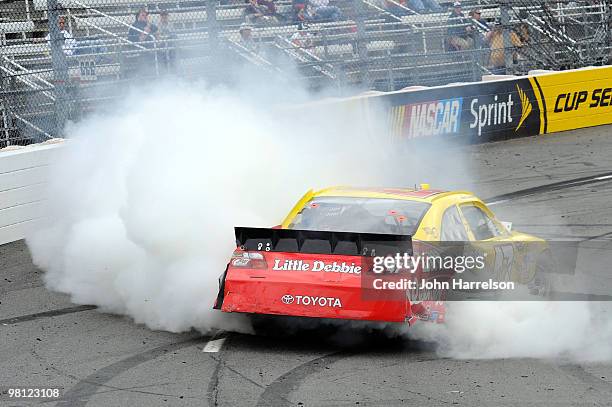 Marcos Ambrose, driver of the Little Debbie Toyota spins during the NASCAR Sprint Cup Series Goody's Fast Pain Relief 500 at Martinsville Speedway on...