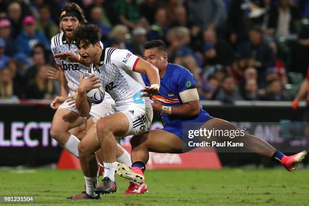 Rameka Poihipi of the Crusaders looks to break from a tackle by AJ Alatimu of the Force during the World Series Rugby match between the Western Force...