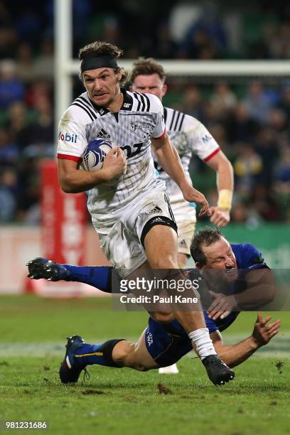 George Bridge of the Crusaders slips from a tackle by Heath Tessmann of the Force during the World Series Rugby match between the Western Force and...