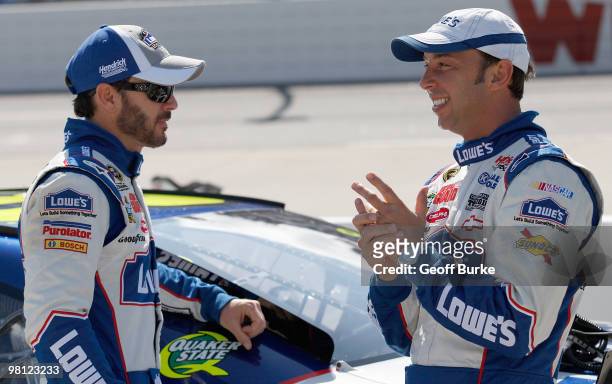 Jimmie Johnson , driver of the Lowe's Chevrolet, talks with crew chief Chad Knaus on the grid prior to the NASCAR Sprint Cup Series Goody's Fast Pain...