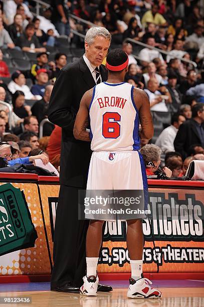 Head coach Kim Hughes and Bobby Brown of the Los Angeles Clippers talk on the court during the game against the Atlanta Hawks at Staples Center on...
