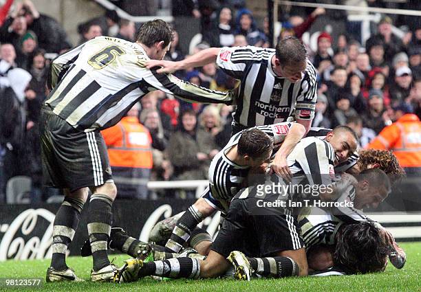 Jose Enrique of Newcastle Unitedis mobbed after scoring the second goal during the Coca Cola Championship match between Newcastle United and...