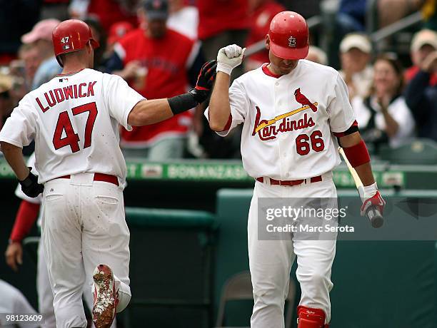 Ryan Ludwick celebrates his solo home run against the Minnesota Twins with teammate Allen Craig at Roger Dean Stadium on March 29, 2010 in Jupiter,...