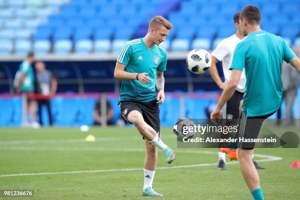 Marco Reus of Germany plays the ball with his team mate Julian Draxler during the Germany Training & Press Conference at Fisht Stadium on June 22,...