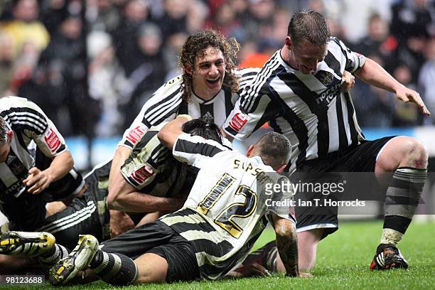 Newcastle players mob Jose Enrique of Newcastle United after he scored the second goal during the Coca Cola Championship match between Newcastle...