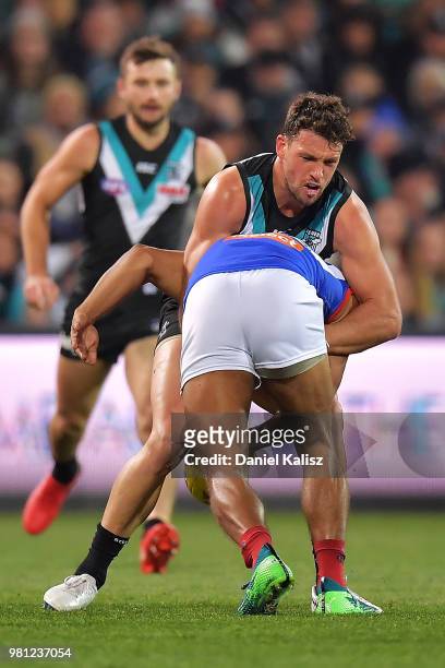 Travis Boak of the Power tackles Neville Jetta of the Demons during the round 14 AFL match between the Port Adelaide Power and the Melbourne Demons...