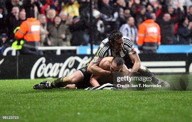 Jose Enrique of Newcastle United celebrates with Jonas Gutierrez after scoring the second goal during the Coca Cola Championship match between...