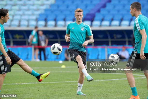 Marco Reus of Germany plays the ball with his team mate Julian Draxler during the Germany Training & Press Conference at Fisht Stadium on June 22,...