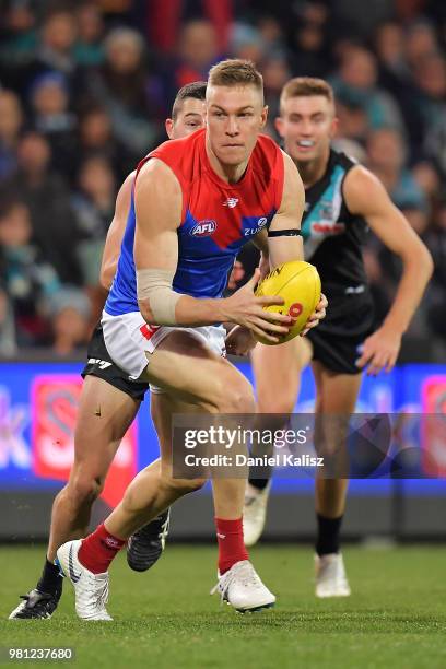 Tom McDonald of the Demons runs with the ball during the round 14 AFL match between the Port Adelaide Power and the Melbourne Demons at Adelaide Oval...