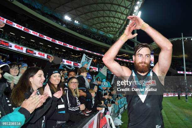 Charlie Dixon of the Power celebrates with fans after the round 14 AFL match between the Port Adelaide Power and the Melbourne Demons at Adelaide...